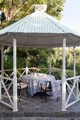 Romantic seating area in gazebo with tent roof