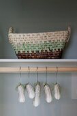Detail of hangers and basket in cupboard