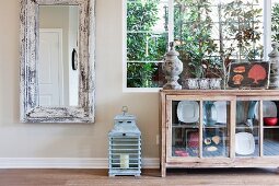 Rectangular mirror and sideboard by window