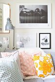 Gallery of pictures and desk lamp above corner sofa with retro scatter cushions
