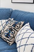 Scatter cushions on sofa with denim upholstery