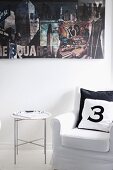 Number printed on scatter cushions on armchair and tray table below photo collage on wall