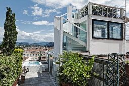 Contemporary penthouse with external staircase leading to raised roof terrace