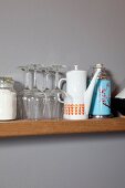 Wine glasses, 70s coffee pot and retro thermos flask on narrow kitchen shelf