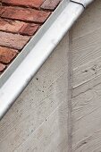 Structural detail of exterior ramp with brick paving and wooden formwork imprints on exposed concrete wall
