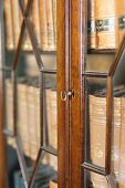 Collection of antiquarian books in glass-fronted cabinet