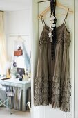 Cocktail dress hanging on door and view of dressing table
