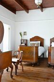 Antique, Biedermeier-style twin beds in simple bedroom