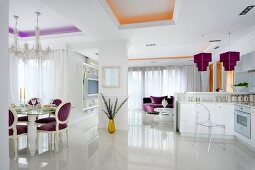 Glossy white floor in elegant, open-plan living space with purple and gold accents