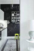 Kitchen with decorative black and white floor tiles and chalkboard wall
