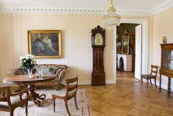 Interior with antique, Biedermeier furniture, oil painting and long-case clock