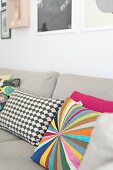 Colourful and patterned scatter cushions on ecru sofa