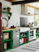 Rustic kitchen with functional counter and green-painted base units