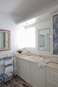 Blue and white bathroom with panelled base units