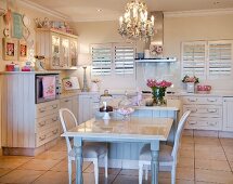 Dining area and chandelier in cream kitchen