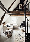 Sofa, Ohrensessel und Klassiker Beistelltisch, davor Teppich mit geometrischem Muster, Wendeltreppe zur offenen Galerieebene mit Bücherecke