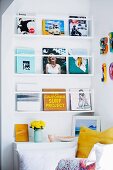 Books on wall-mounted shelves in colourful reading corner
