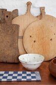 Wooden chopping boards and bowl on surface