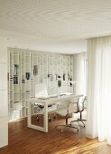 Workspace with Eames Aluminium Chairs and fitted shelving integrated into white interior