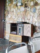 Retro hifi cabinet against stone-clad wall
