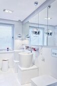 Designer bathroom: extravagant washstands below mirrored cabinet on wall and pendant lamps with spherical chrome lampshades