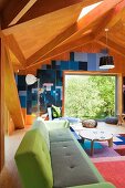 Designer-Sofa mit verschiedenen Grüntönen auf Bezug, in modernem, holzvertäfeltem Wohnraum