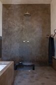 Ethic-style shower with grey-rendered walls and running water