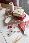 Christmas gifts wrapped in gold and red with labelled tags