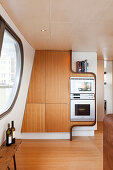 Custom, fitted cupboards with integrated appliances in houseboat kitchen