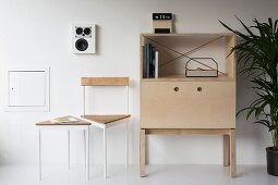 Schlichtes Designermöbel im Wohnbereich mit dreieckigem Beistelltisch und passendem Stuhl