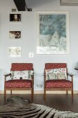 50s armchairs with Missoni covers below framed pictures on wall