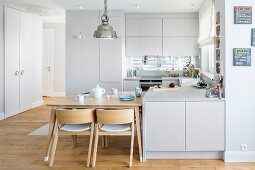 Bright, open-plan fitted kitchen with integrated dining area