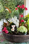 Various vases of king proteas, arum lilies, red tulips, hyacinths, bromeliads and Celosia in large bowl