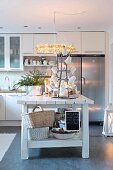 Cosily lit, vintage-style kitchen with island counter