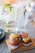 Toffee apples with desiccated coconut on board