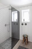 Floor-level shower with smoked glass screen in bright bathroom