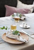 Linen napkin, eucalyptus sprig and wooden plate