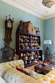 Hat blocks on shelving and yellow Chesterfield sofa in living room