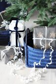 Gifts in blue baskets below Christmas tree