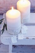 Pillar candles for Advent decorated with sleeves of text