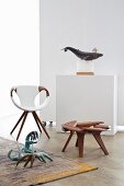 Designer armchair, walnut stool and stylised animal sculptures