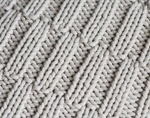 A knitted pattern with offset ribbing (full frame)