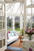 Traditional, vintage-style white conservatory with view of garden