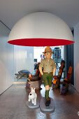 Tintin and Snowy statues under designer lamp