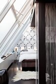 Monochrome bedroom under glass ceiling