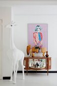 White giraffe sculpture in front of home bar