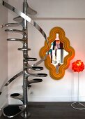 Shiny retro newel staircase in corner next to pop-art mirror with yellow curved frame