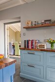 Country-house kitchen with pale blue fronts and walnut worksurface