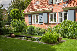 Brick house and rectangular garden pond