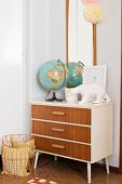 Globe and polar bear ornament on top of retro chest of drawers